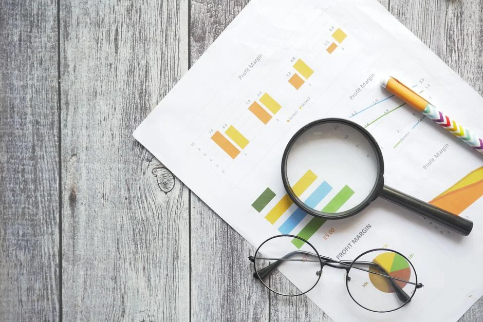 A top view on charts and smartphone in an office, showcasing data analytics.